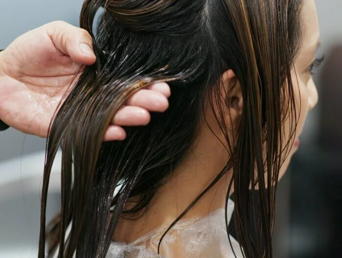 Woman having hair treatment in hair salon